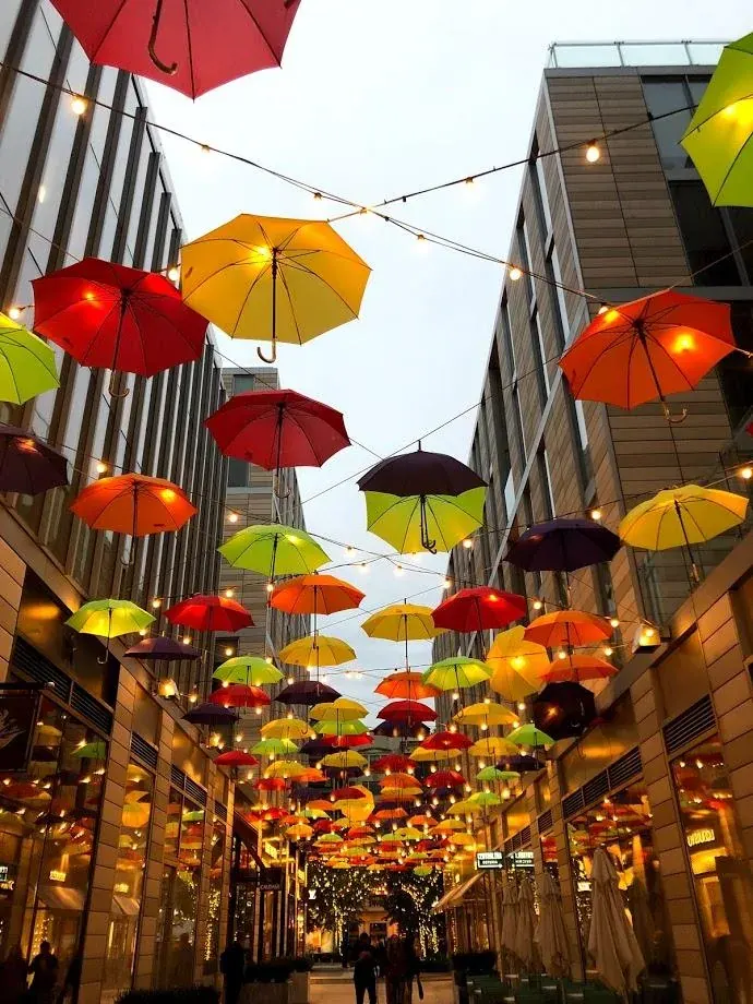 Colorful umbrellas hanging above an urban alley for a service level agreement lawyer page