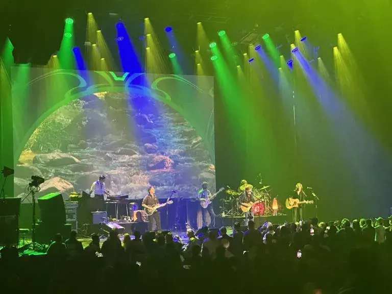 Live band performing on stage before an audience for SaaS legal services content