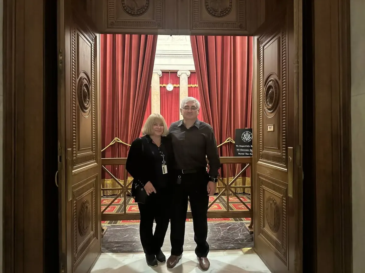 Two adults standing in an ornate interior doorway on a stock option plan legal services page